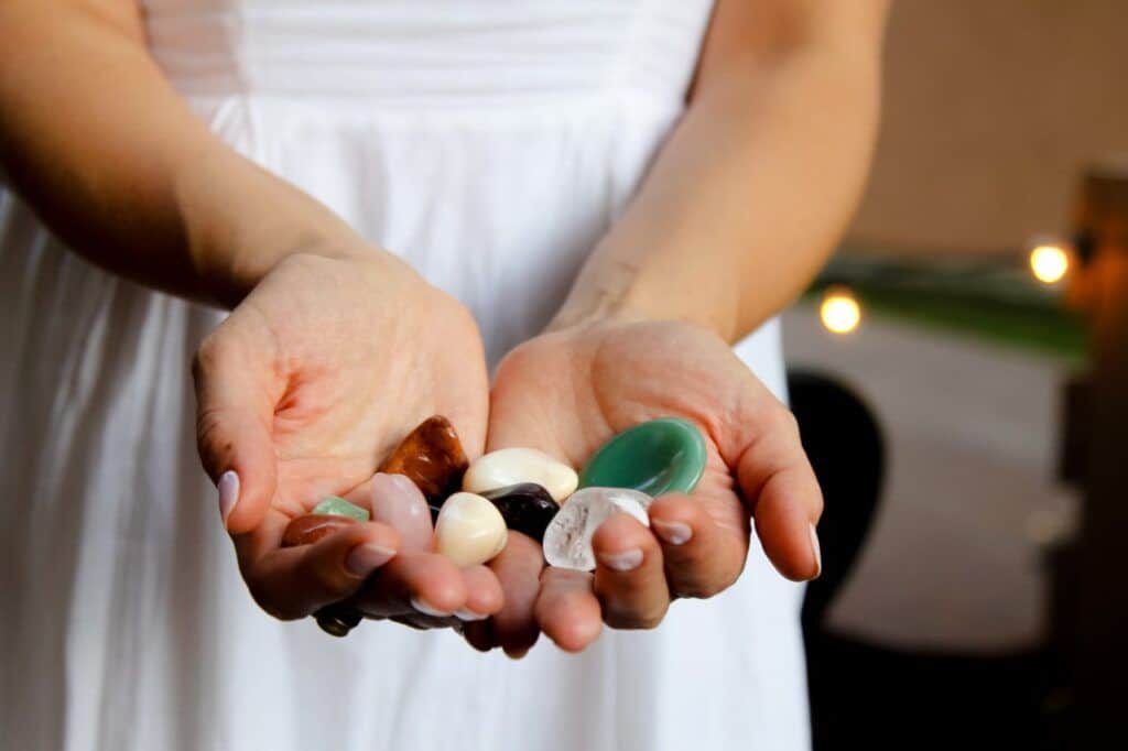 hands holding an assortment of crystals